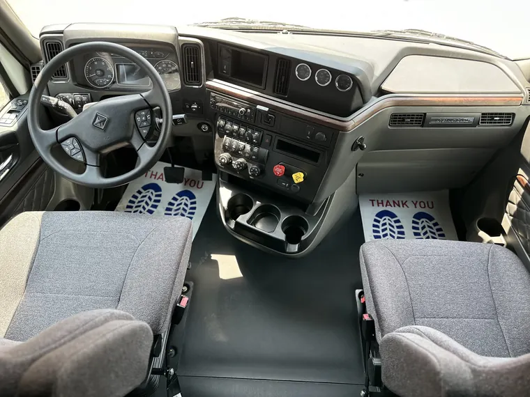 Cab of a new International tractor with dashboard and two seats