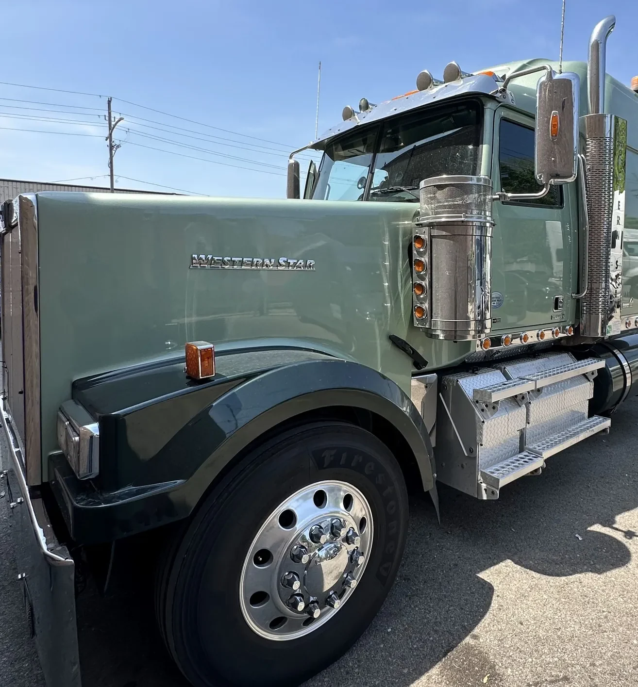 Green Western Star tractor with chrome stacks